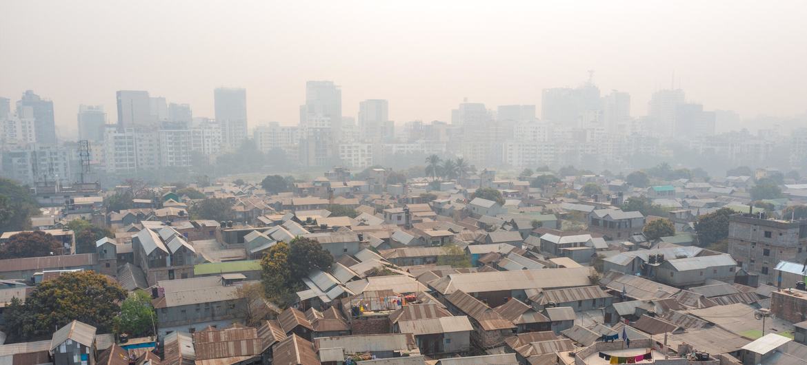 In Dhaka, stark inequality is laid bare as informal settlements sprawl in the foreground, shadowed by rising high-rises in the distance. In Dhaka, stark inequality is laid bare as informal settlements sprawl in the foreground, shadowed by rising high-rises in the distance.