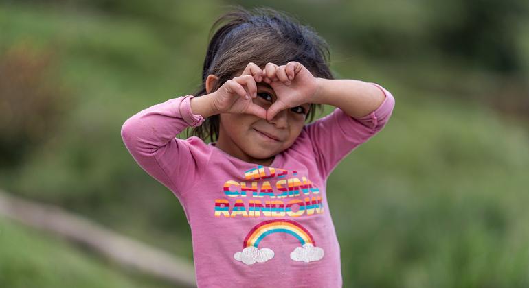 A five-year-old girl makes a heart with her hands in the rural community of Chajul, in Quiche Guatemala.