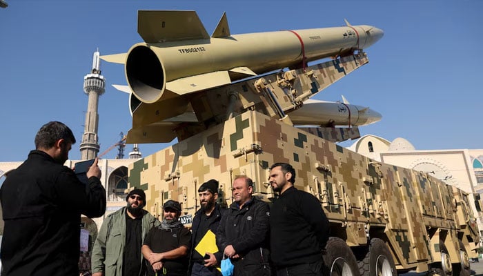 Iranians take photos during an exhibition displaying missiles of the kind used during Irans retaliatory strike on the U.S Ayn al-Asad military base in 2020 are seen on display at Imam Khomeini Grand Mosalla in Tehran January 7, 2022. — Reuters