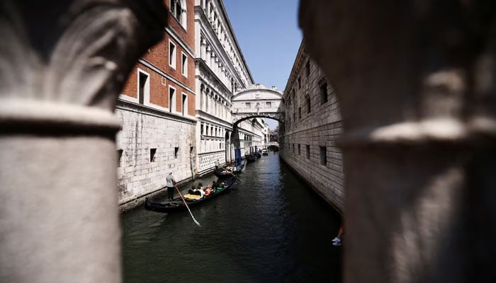 Gondoliers ride their gondolas through the Venice Canal ahead of the expected wedding of Amazon founder Jeff Bezos and Lauren Sanchez, in Venice, Italy, June 22, 2025. — Reuters