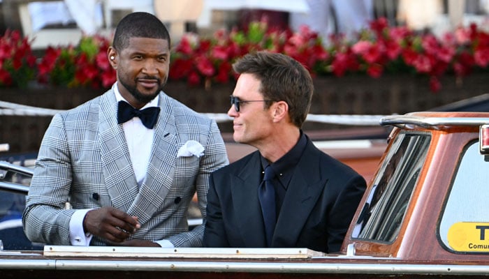 US singer Usher Raymond IVl (left) and US football player Tom Brady leave the Gritti Palace Hotel on the wedding day of Amazon founder Jeff Bezos with Lauren Sanchez, in Venice on June 27, 2025. — AFP