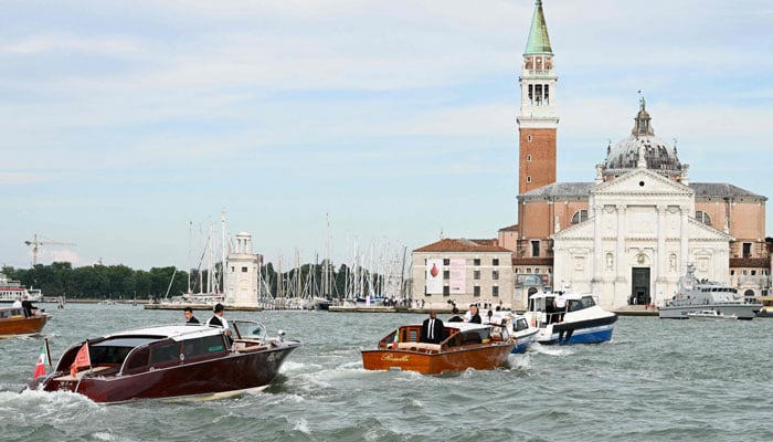 The boat Moa (L) transporting Amazons founder Jeff Bezos is escorted to San Giorgio Maggiore on his wedding day, in Venice on June 27, 2025. — AFP