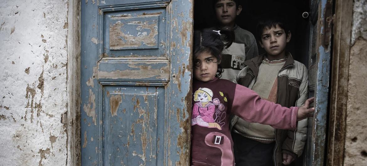 Children stand in the doorway of a home in a poverty stricken neighborhood in Lebanon. (file)