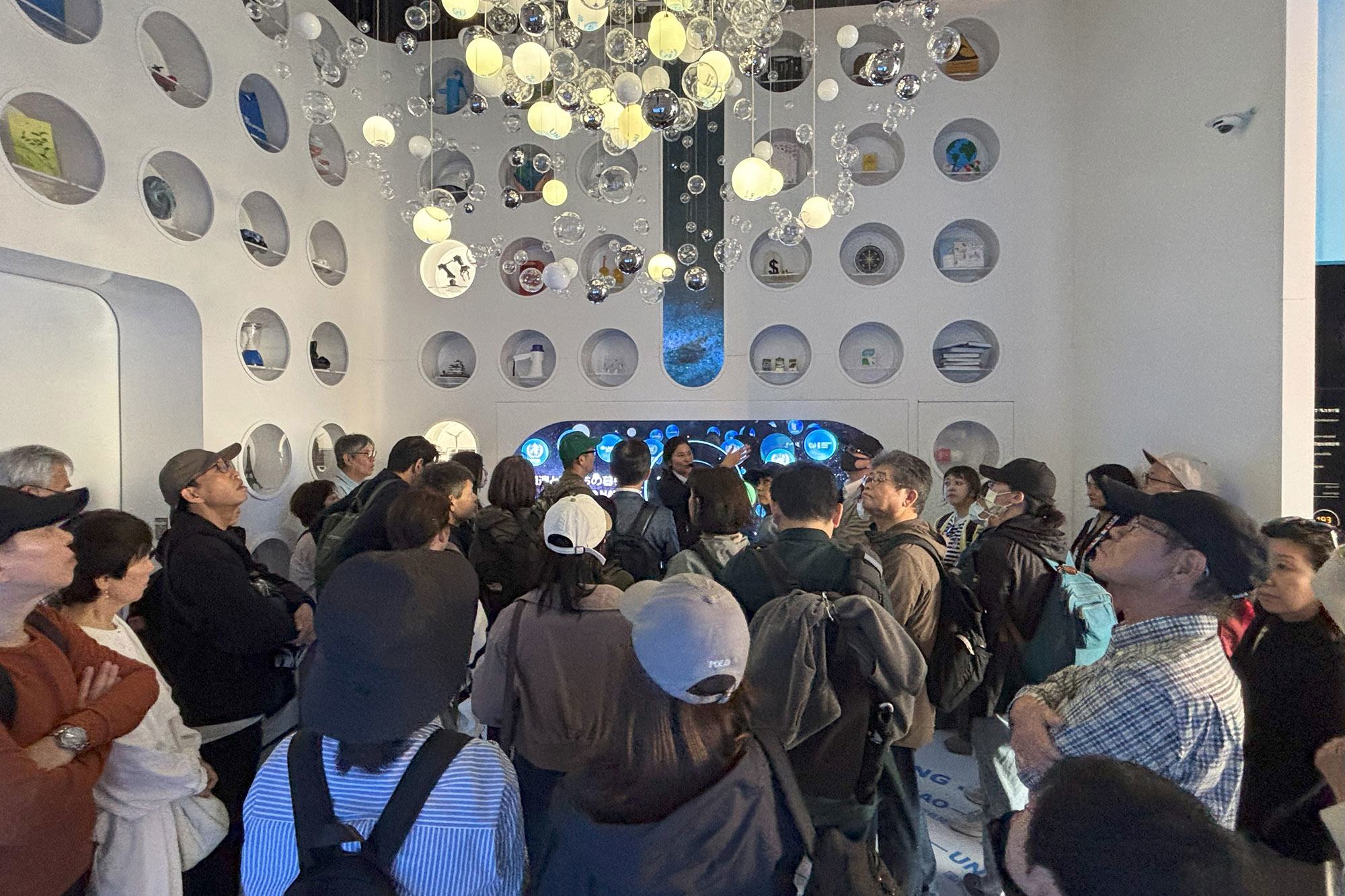 Visitors to the UN Pavilion explore the 'orb' room.
