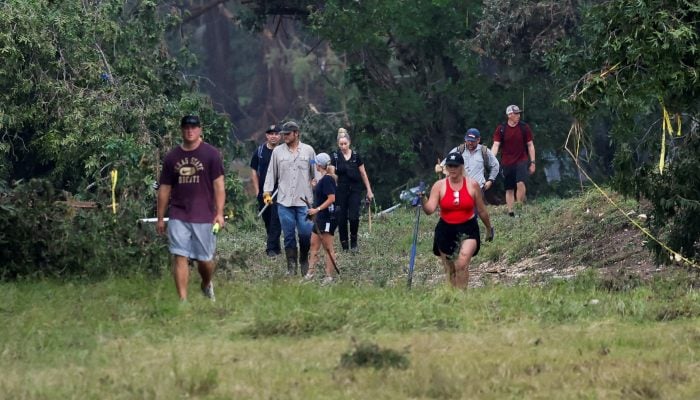 People search the area, following flash flooding, in Hunt, Texas, US on July 6, 2025. — Reuters