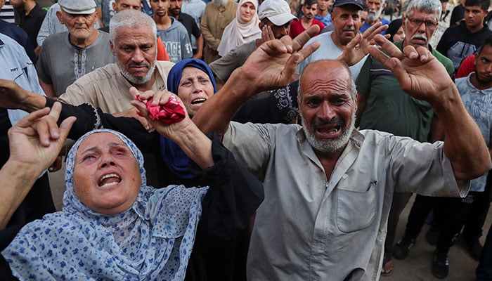 People mourn at a funeral of Palestinians killed by Israeli fire while trying to receive aid and others who were killed in an overnight Israeli strike on July 26, 2025. — Reuters
