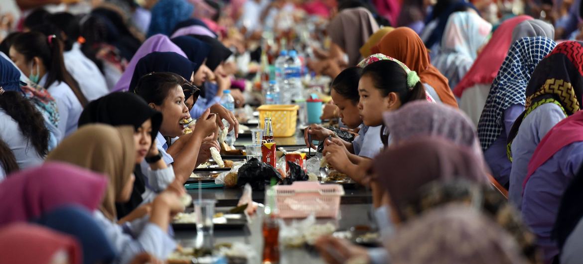 Workers take their lunch break at a garment factory in Indonesia.