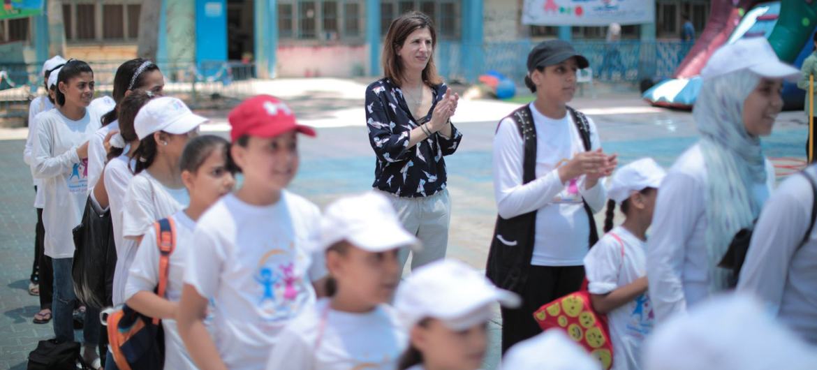 The author plays with students enjoying the "summer fun weeks" games in an UNRWA school in the Gaza Strip in 2023. (file)