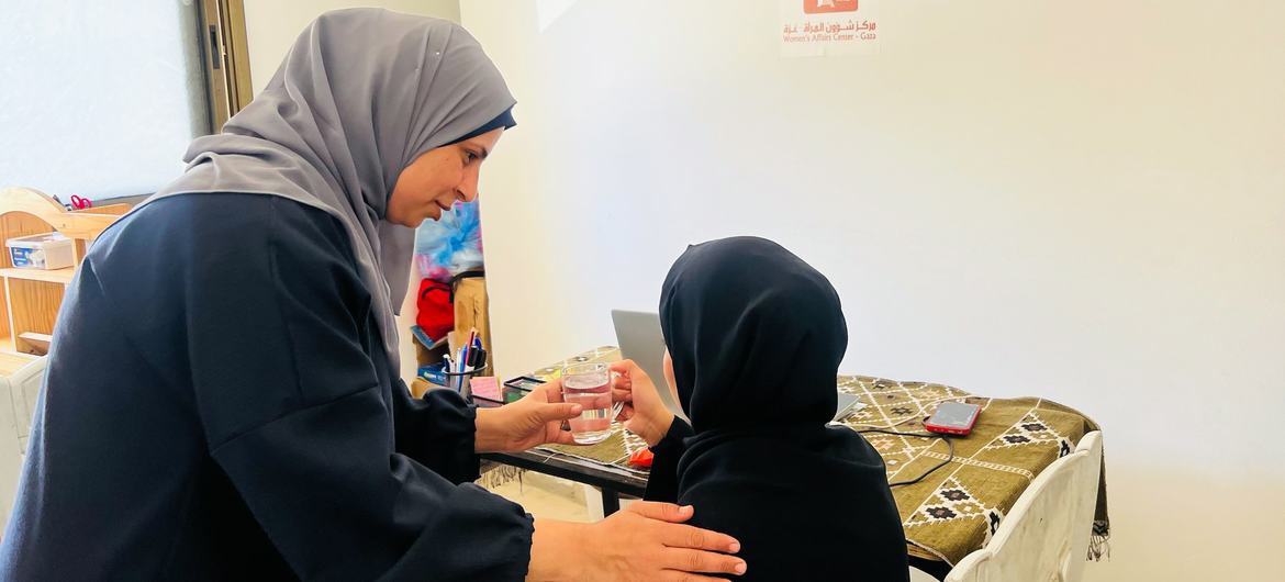 Salma, left, is a mother of four and gender-based violence case manager in Khan Younis.