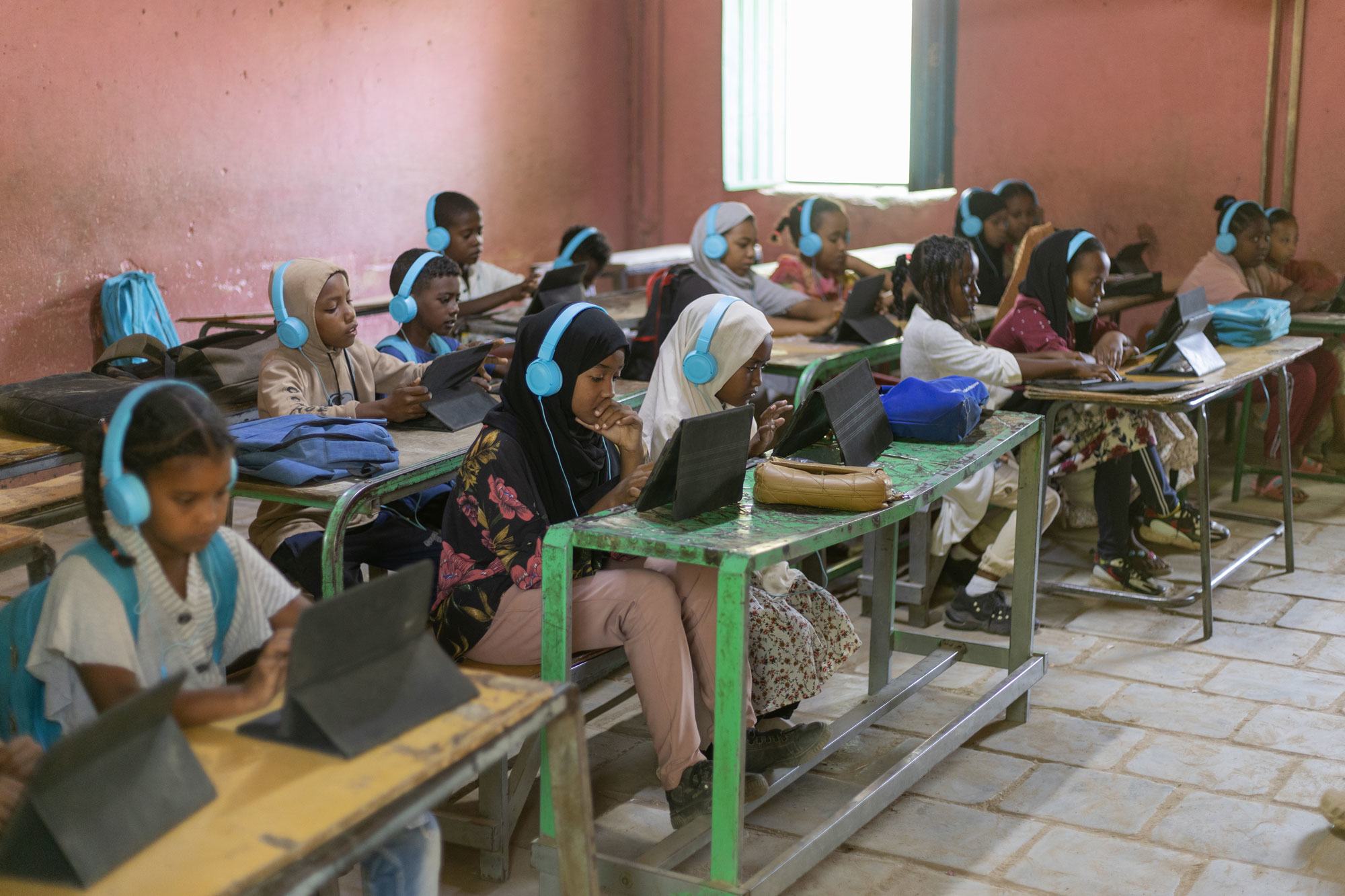 Children in Kassala, Sudan, study with the help of digital tablets. 