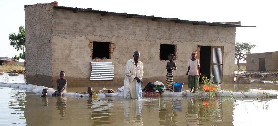 A family outside their flood damaged home in N'Djamena, Chad. (file)