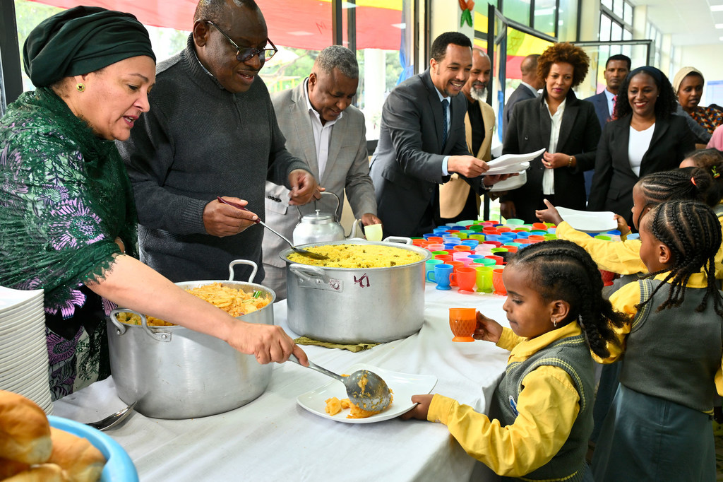 UN Deputy Secretary-General Amina  Mohammed (left) serves food to children at a UN Food Systems Summit event in Addis Ababa, Ethiopia.