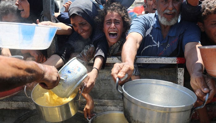Palestinians wait to receive food from a charity kitchen, amid a hunger crisis, in Gaza City, August 2, 2025. — Reuters