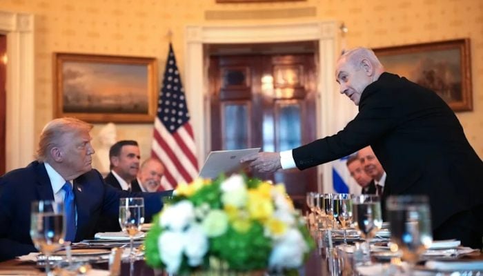 Israeli Prime Minister Benjamin Netanyahu (R) presents a copy of a letter he sent to the Nobel Committee to nominate US President Donald Trump (L) for the Nobel Peace Prize. — AFP