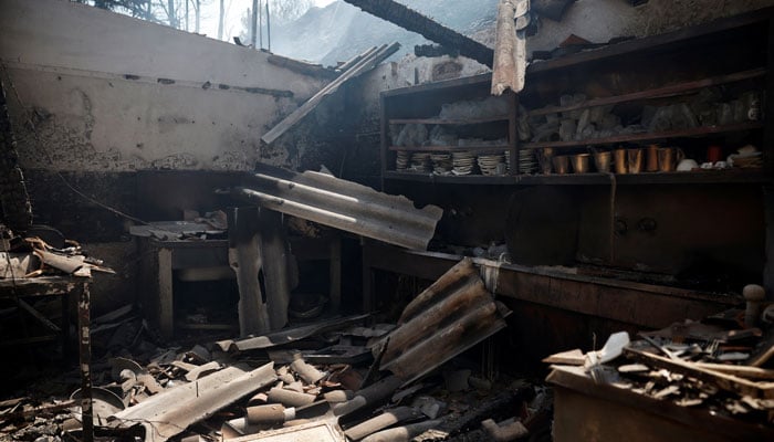 The interior of a burnt tavern following a wildfire in Kaminia, near Patras, Greece, August 13, 2025. — Reuters