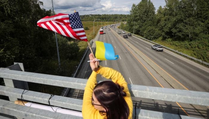 A demonstartor holds US and Ukrainian flags in solidarity with Ukraine, ahead of the meeting between US President Donald Trump and Russian President Vladimir Putin, in Anchorage, Alaska, US, August 14, 2025. — Reuters