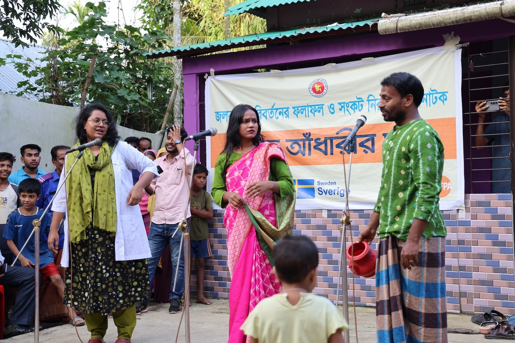 Villagers gather for an afternoon street drama in Bodipur, Kurban Nagar Union, Sunamganj, as part of the Climate Resilience Health System and Community Project.
