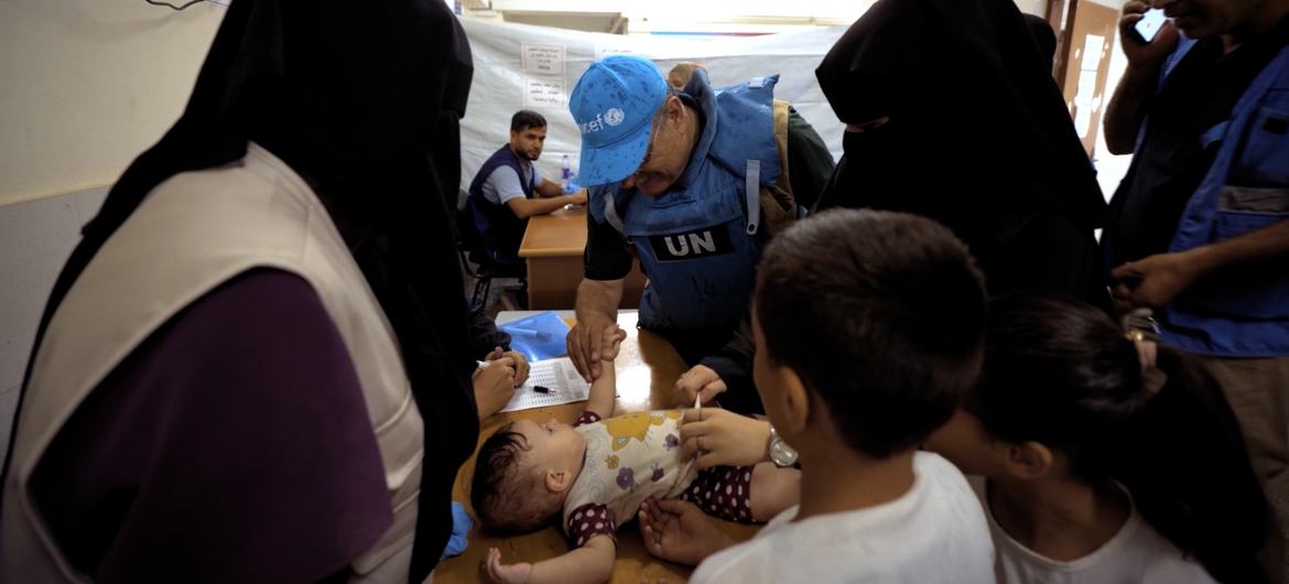 Dr. Younis Awadallah administers a polio vaccine in Gaza.