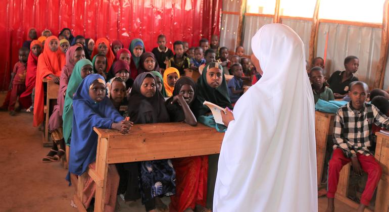 A teacher stands before a classroom in Somalia. 