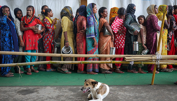 Flood-affected people wait in line to receive free food, distributed at a transit camp, after the water level of river Yamuna rose due to heavy monsoon rains, in New Delhi, India, September 3, 2025. — Reuters