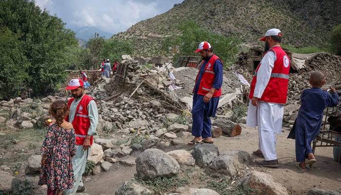 Red Crescent volunteers walk next to damaged houses as they reach Lulam village to help the victims following a deadly magnitude-6 earthquake that struck Afghanistan on Sunday, in Nurgal district, Kunar province, Afghanistan, September 3, 2025. — Reuters