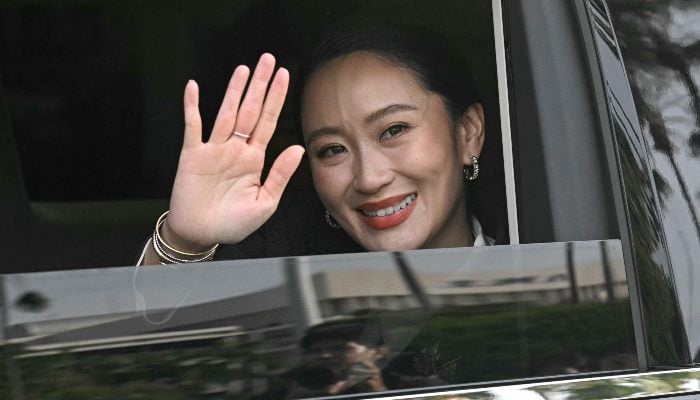 Thailands sacked prime minister Paetongtarn Shinawatra smiles as she leaves Government House after her dismissal by the Constitutional Court in Bangkok on August 29, 2025. — AFP