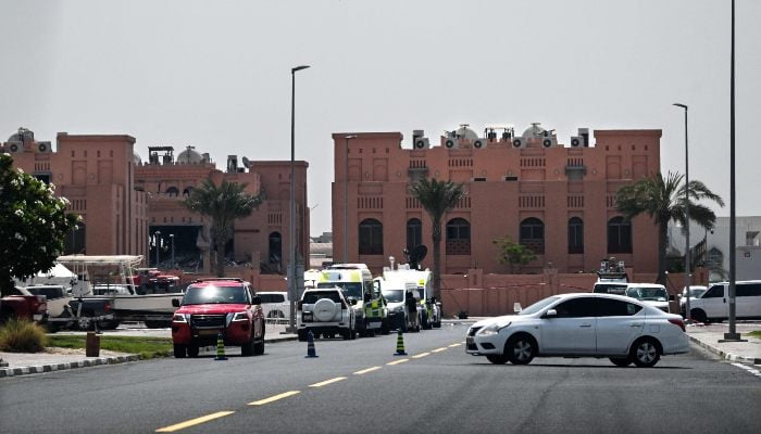 A picture taken from a distance shows the damaged building (L) in the compound housing members of Hamass political bureau which was targeted the previous day by an Israeli strike in Qatar´s capital Doha, on September 10, 2025. — AFP