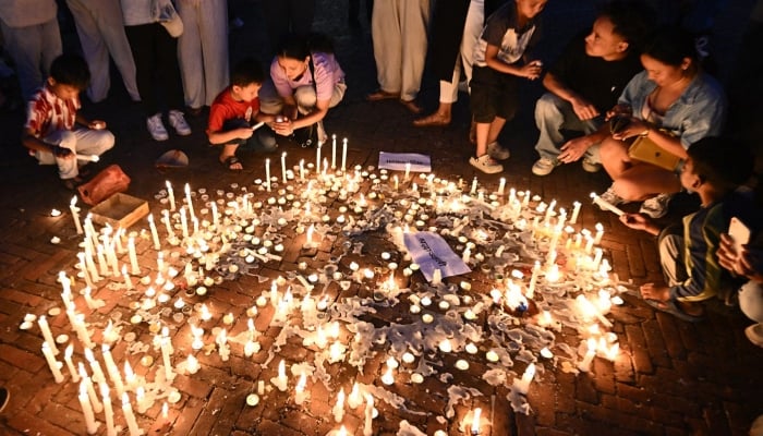 People light candles during a silent tribute held for victims killed in the clashes against police personnel, at the Boudhanath Stupa in Kathmandu, Nepal, on September 13, 2025. — AFP