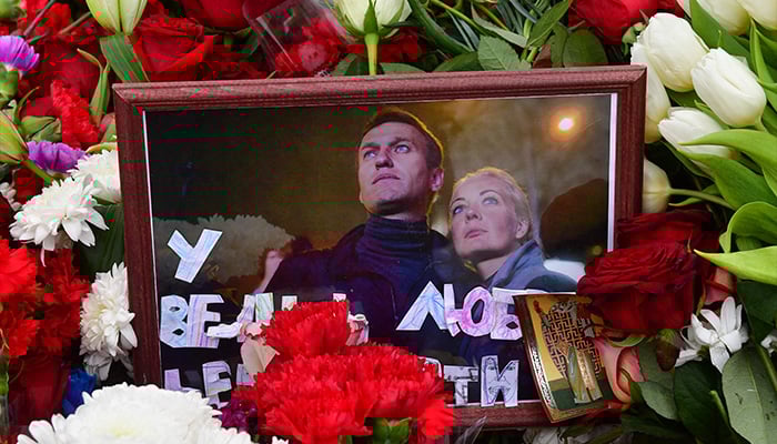 A photograph of Alexei and Yulia Navalny is seen on the grave of Russian opposition leader Alexei Navalny at the Borisovo cemetery in Moscow on March 2, 2024, the next day after Navalnys funeral. — AFP