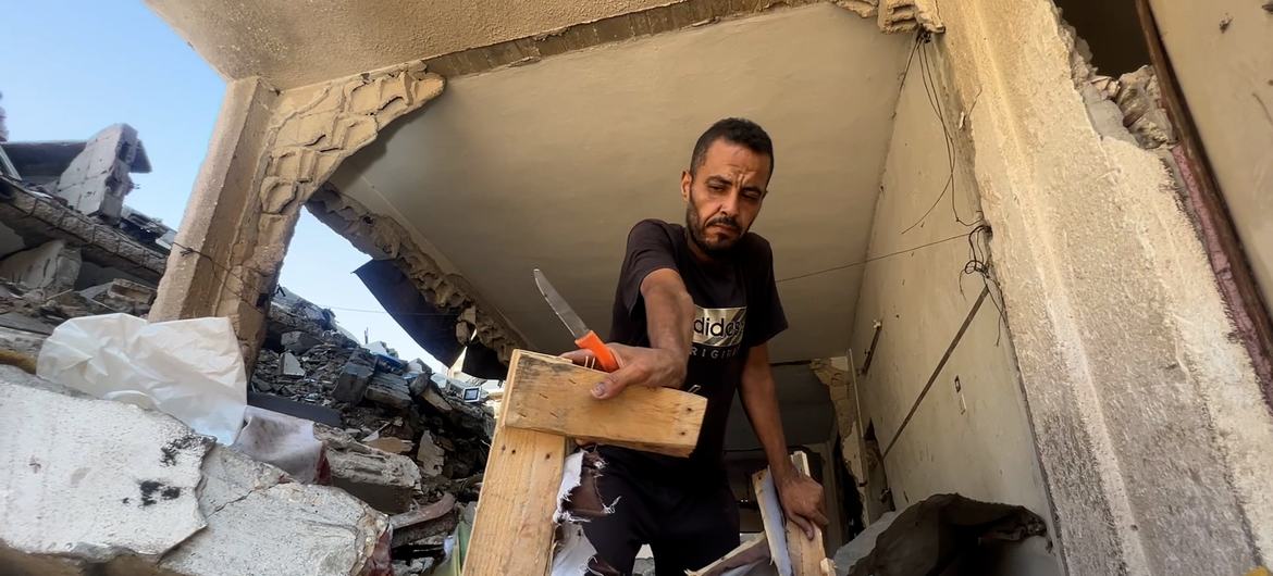 Hossam Madi, a resident of Sheikh Radwan in northern Gaza City removes some of his belongings from his destroyed home.