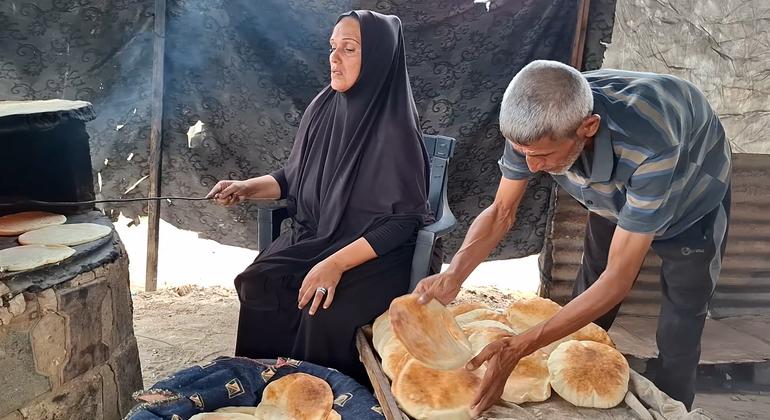 Um Mohammed Abu Zuaiter working with her husband at their clay oven