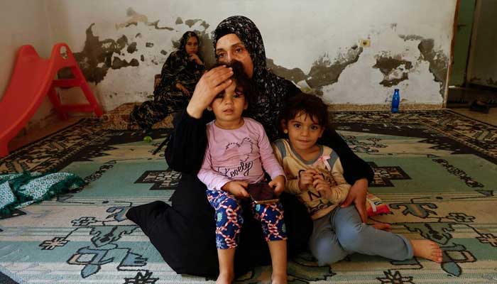Palestinian woman Samah Abu Latifa, who fled her home amid Israeli strikes, shelters with her family in a kindergarten, in khan Younis in the southern Gaza Strip, October 10, 2023. — Reuters