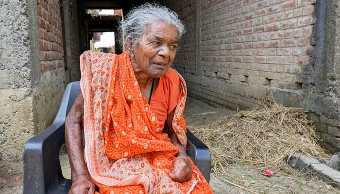 Jitni Devi, whose name has been excluded from the state voter list, sits outside her home in Patna, India, October 14, 2025. — Reuters