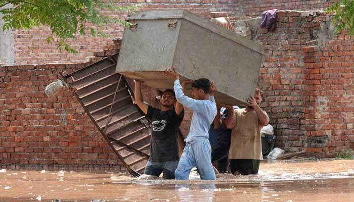 Residents carry their belongings to a safer place as they move through a water-logged residential area located on the banks of the flooded Ravi river, after India opened the gates of major dams on rivers in its part of Kashmir after the heavy rains, in Lahore, Pakistan, August 28, 2025. — Reuters