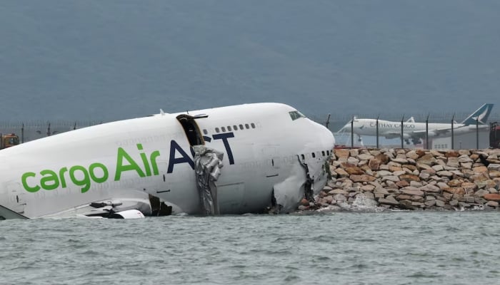 A cargo plane lies partially in the sea after veering off the runway during landing at Hong Kong International Airport in Hong Kong, China, October 20, 2025. — Reuters
