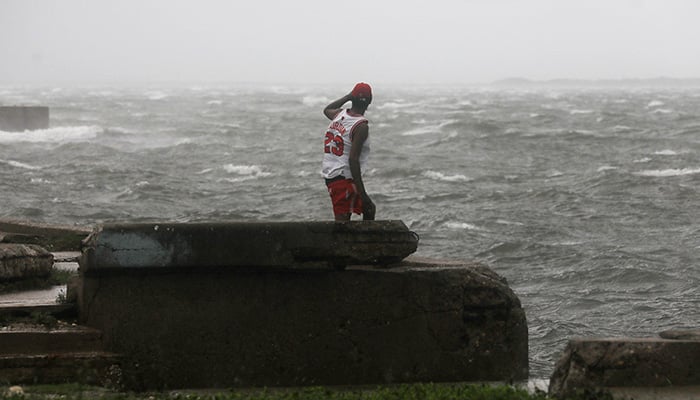 A man watches the waves, as Hurricane Melissa approaches, in Kingston, Jamaica, October 28, 2025. — Reuters
