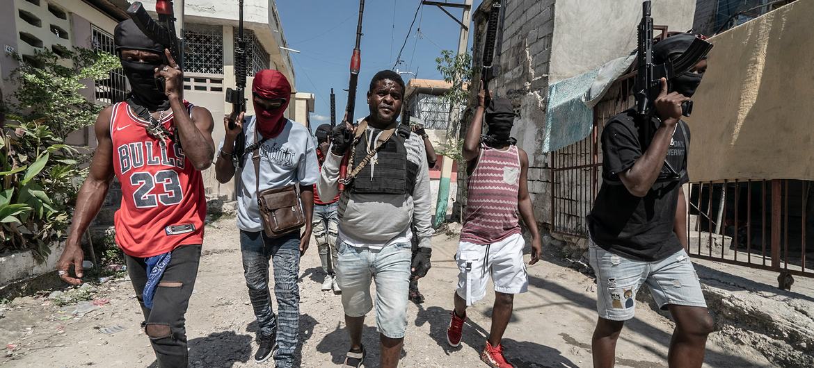 Gang members walk through a neighbourhood in Port-au-Prince.