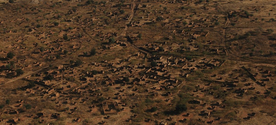 An aerial view of charred terrain and burnt-out structures in a village located between the cities of Nyala (capital of South Darfur) and El Geneina (capital of West Darfur). Hundreds of villages were attacked, looted and destroyed. (2004 photo)