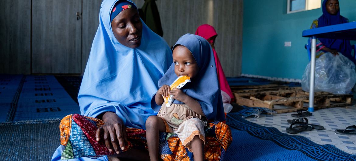 A two-year-old girl eats a nutritional supplement at a health centre in Maiduguri in northern Nigeria. 