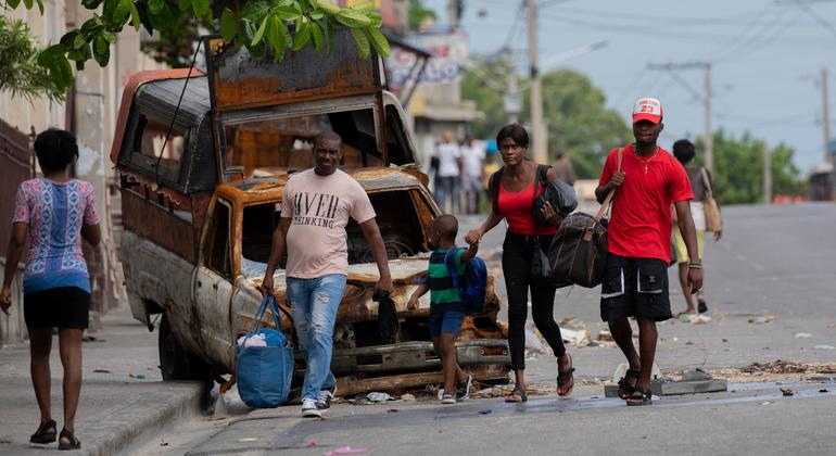 People flee the neighbourhood of Solino in Port-au-Prince following gang attacks there in May 2024.