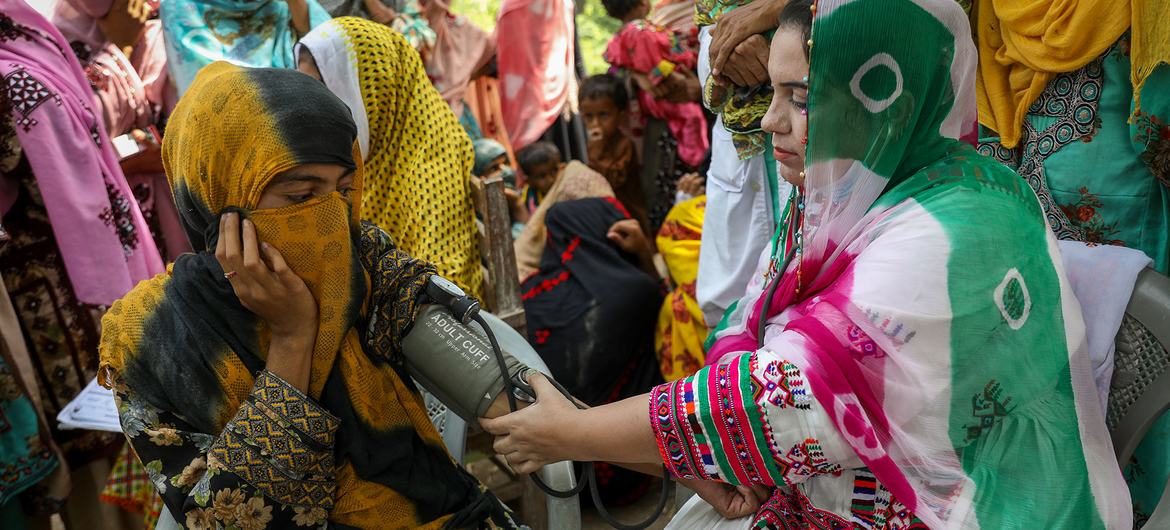 A health worker conducts blood pressure tests in rural India.