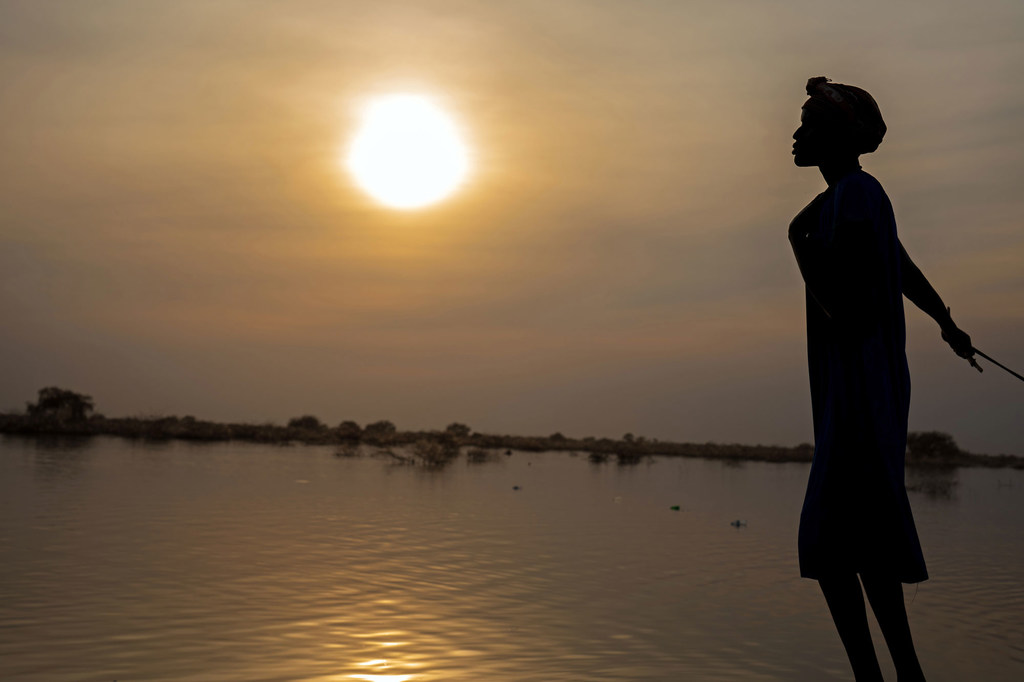 A woman is pictured in front of flooded fields in Bentiu, South Sudan.