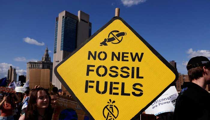 Demonstrators march across the Brooklyn Bridge, rallying to call an end to the era of fossil fuel, New York City, U.S., September 20, 2024. — Reuters