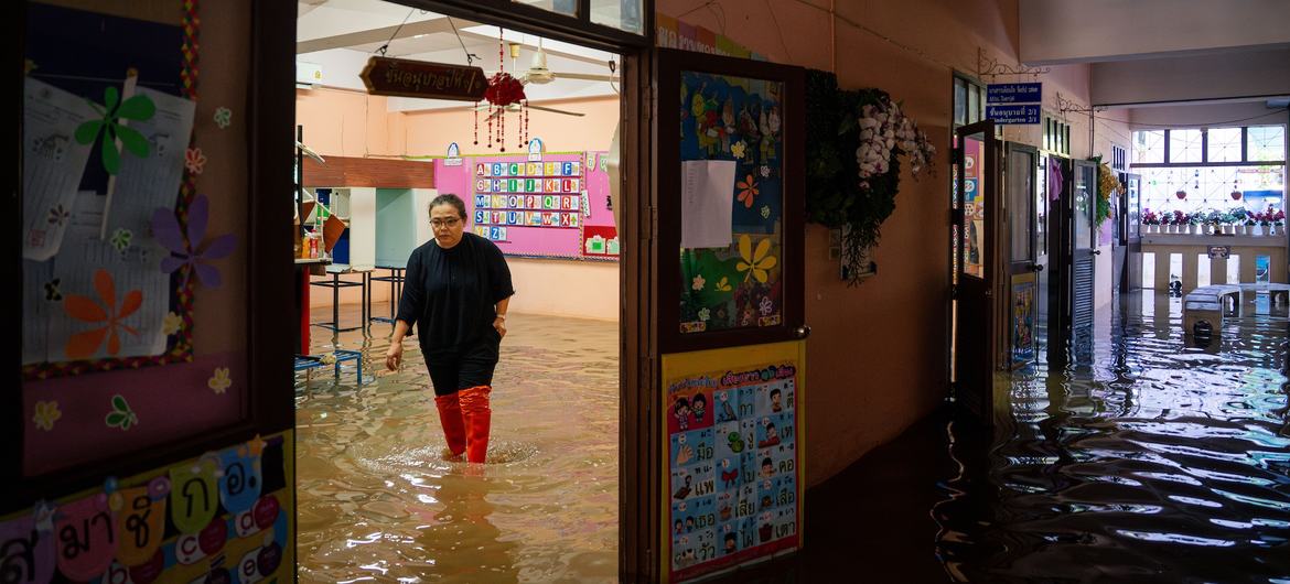 A teacher inspects the damage in a kindergarten classroom at a school in Thailand.	