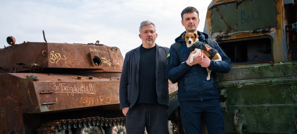 Bomb-sniffing deminer dog Patron and owner Mykhailo "Misha" Iliev, with Giles Duley, UN Global Advocate