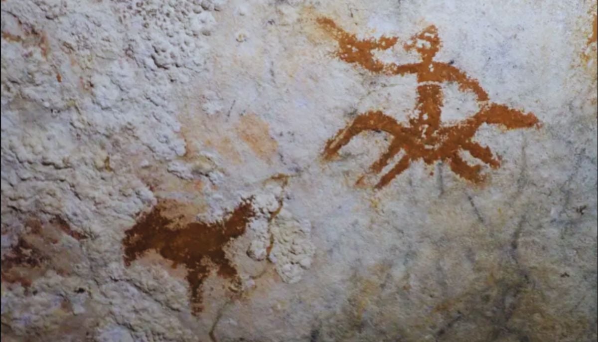 Worlds oldest artwork depicts a hand-painted stencil inside a cave rock—a person riding a horse alongside a chicken.