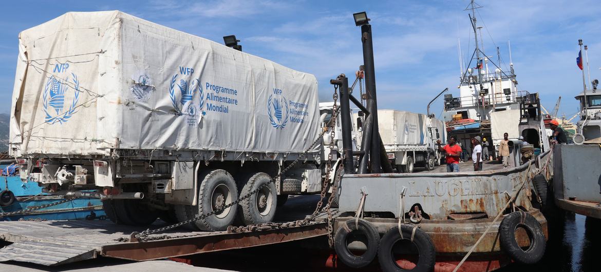 Trucks carrying aid to Haitians are loaded onto boats to bypass areas controlled by gangs.