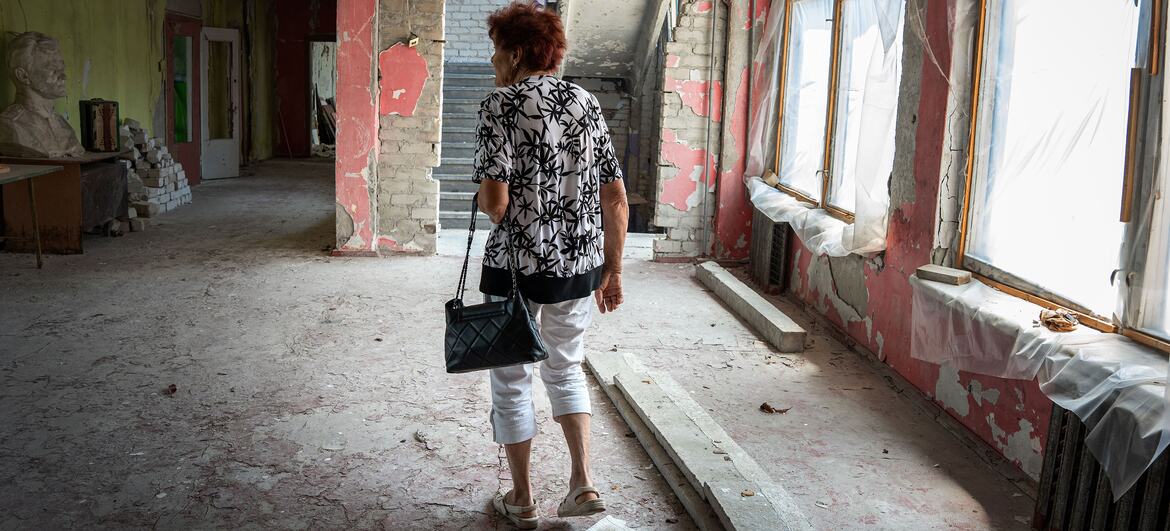 Maryna walks through a destroyed school in Kherson where she used to teach Ukrainian literature.