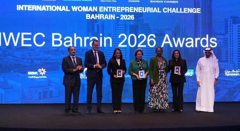 Awards ceremony for the International Woman Entrepreneurial Challenge Bahrain 2026, featuring awardees holding framed certificates on stage.