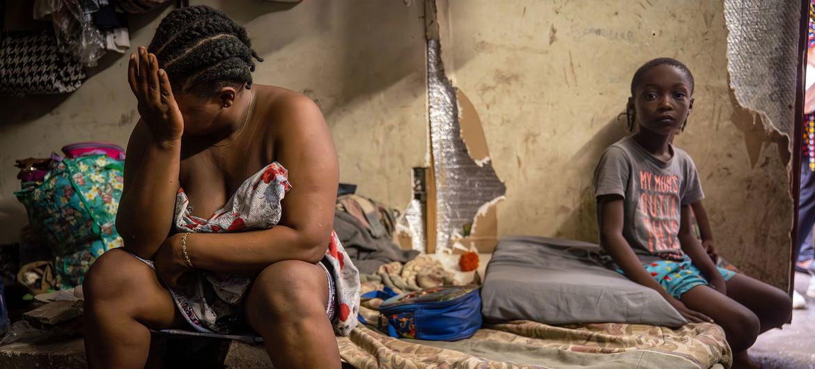 A mother and child find shelter in a municipal building in Port-au-Prince after fleeing violence.